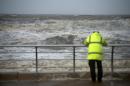 A man watches the sea during stormy conditions in Blackpool, northwest England, on October 21, 2014