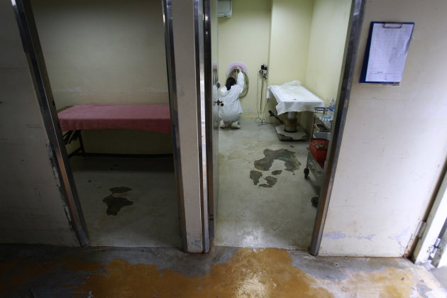 In this photo taken on Monday, April 9, 2012, a nurse prepares the room used to euthanize dogs at a government-run shelter in Taoyuan, northern Taiwan. In an ongoing project, Taiwanese photographer To