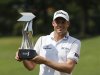 Watney of the U.S. poses with his trophy after winning the Malaysia's Asia Pacific Classic golf tournament in Kuala Lumpur