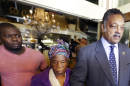 Nowai Korkoya, mother of Ebola patient Thomas Eric Duncan, center, walks with the Rev. Jesse Jackson, right, and Josephus Weeks, Duncan's nephew after they spoke to reporters Tuesday, Oct. 7, 2014, in Dallas. Duncan's family has gathered in Dallas to check on his condition. (AP Photo/LM Otero)