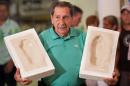 FILE.- In this Dec, 29, 2009 file photo Uruguay?s former soccer player Alcides Edgardo Ghiggia holds the prints of his feet that will be placed on Brazil's Soccer Walk of Fame in Maracana stadium in Rio de Janeiro, Brazil. Ghiggia, who scored the winning goal in the final game of the 1950 World Cup to give Uruguay a stunning 2-1 victory over Brazil, still recalled as Brazil's greatest defeat, has died. He was 88.(AP Photo/Felipe Dana, File)