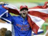 A Puerto Rico fan cheers during the seventh inning of the second-round elimination game of the World Baseball Classic against the United States, Friday, March 15, 2013, in Miami. Puerto Rico defeated the U.S. 4-3. (AP Photo/Wilfredo Lee)