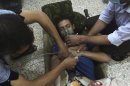 File photo of a man, affected by what activists say is nerve gas, breathing through an oxygen mask in the Damascus suburbs of Jesreen