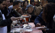 Supporters and visitors line up to receive free meals at the Occupy Wall Street protest in Zuccotti Park, Tuesday, Oct. 25, 2011 in New York. Some businesses and residents are losing patience with the protesters in Zuccotti Park, the unofficial headquarters of the movement that began in mid-September. (AP Photo/Bebeto Matthews)
