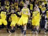 The Michigan bench reacts after their 56-51 win over Ohio State during an NCAA college basketball game in Ann Arbor, Mich., Saturday, Feb. 18, 2012. (AP Photo/Carlos Osorio)