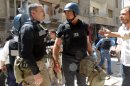 UN arms experts inspect a site suspected of being hit by chemical weapons in a Damascus suburb on August 28, 2013