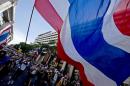 Thai anti-government protesters wave national flags during a rally in Bangkok on May 12, 2014