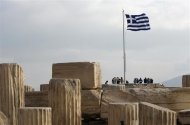 A Greek national flag flies at the archaeological site of the Acropolis Hill in Athens November 3, 2011.  REUTERS/John Kolesidis