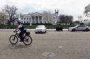 A Secret Service rides his bike on Pennsylvania Avenue outside the White House in Washington, Tuesday, April 7, 2015. The White House, State Department, and Capitol were all affected by reports of widespread power outages across Washington and its suburbs Tuesday afternoon. (AP Photo/Susan Walsh)