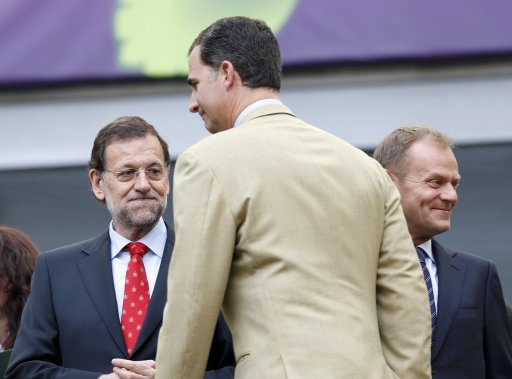 Spain's Crown Prince Felipe walks past Spain's Prime Minister Rajoy as they wait for the start of their Group C Euro 2012 soccer match between Spain and Italy in Gdansk