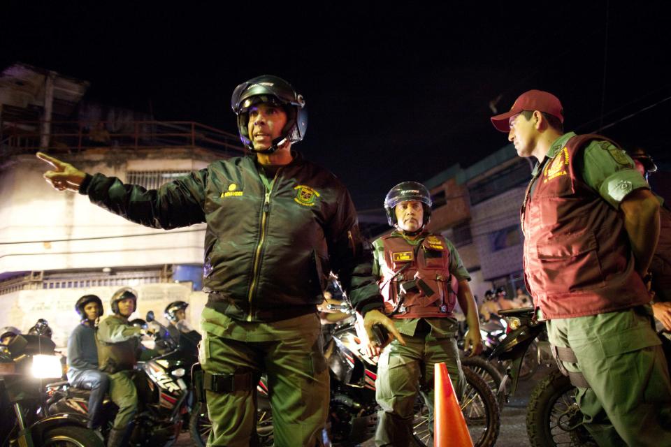 In this May 14, 2013 photo, Gen. Antonio Benavides, left, gives instructions to a soldiers during a security operation that is part of the "Secure...