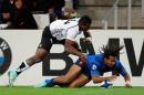 France's Teddy Thomas, right, scores a try despite a tackle from Fiji's Watisoni Votu during the rugby union international match at the Velodrome Stadium, in Marseille, southern France, Saturday, Nov. 8, 2014. (Claude Paris/AP Photo)
