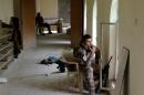 An Iraqi special forces soldier smokes while seated in his position inside a mosque in Mosul