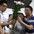 A grieving woman is assisted to lay flowers for victims of a high speed train crash at the crash site in Wenzhou, southeastern China's Zhejiang province, Friday, July 29, 2011.  Chinese Premier Wen Jiabao vowed Thursday to punish any corrupt person found responsible for Saturday's crash that killed at least 39 people and triggered public anger over its handling. (AP Photo/Ng Han Guan)