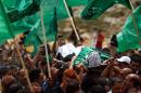 Mourners carry the body of Palestinian youth Mohammed Udeh, a day after he was shot dead by Israeli forces during clashes to mark "Nakba", during his funeral procession in Bir Zeit on May 16, 2014