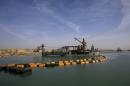 Dredger float on a new section of the Suez canal during a media tour in Ismailia, Egypt, Wednesday, Feb. 4, 2015. The head of the Suez Canal Authority, Mohab Mameesh, says work is on schedule and that so far, 86 percent of the dry digging and 21 percent of the dredging has been completed, with the new section expected to be completed in August 2015. (AP Photo/Hassan Ammar)