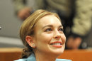 Lindsay Lohan smiles during a progress report on her probation for theft charges at Los Angeles Superior Court Thursday, March 29, 2012. A judge ended Lindsay Lohan's supervised probation on Thursday, giving the actress her freedom after nearly two years of constant court hearings and threats of jail. Lohan thanked Superior Court Judge Stephanie Sautner for her patience and let out a sigh of relief as she exited the courtroom after the brief hearing. (AP Photo/Joe Klamar, Pool)