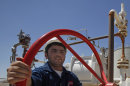 FILE - In this May 31, 2009 file photo, an employee works at the Tawke oil fields in the semiautonomous Kurdish region in northern Iraq. Iraq is threatening to seize oil exports made without its consent and sue companies dealing in what it sees as contraband crude just days after the country's self-rule Kurdish region began unilaterally exporting oil. (AP Photo/Hadi Mizban, File)