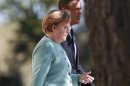 German Chancellor Merkel and U.S. President Obama walk together during the family picture event during the G20 summit in St.Petersburg