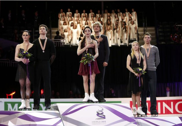 Virtue and Moir of Canada, Davis and White of the U.S. and Bobrova and Soloviev of Russia on the podium after the ice dance free dance at the ISU World Figure Skating Championships in London, Ontario