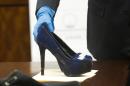 Prosecutor John Jordan sets down a stiletto shoe entered into evidence during the trial against Ana Lilia Trujillo Tuesday, April 1, 2014, in Houston. Trujillo, 45, is charged with murder, accused of killing her 59-year-old boyfriend, Alf Stefan Andersson with the heel of a stiletto shoe, at his Museum District high-rise condominium in June 2013. (AP Photo/Houston Chronicle, Brett Coomer) MANDATORY CREDIT