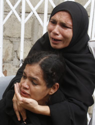 Pakistani women mourn the death of their family member by a target shooting in Karachi, Pakistan Thursday, Aug 18, 2011. A wave of violence killed 33 people in the last 24 hours in Pakistan's largest city, with many of the victims tortured, shot and stuffed in sacks that were dumped on the streets, officials said Thursday. (AP Photo/Fareed Khan)