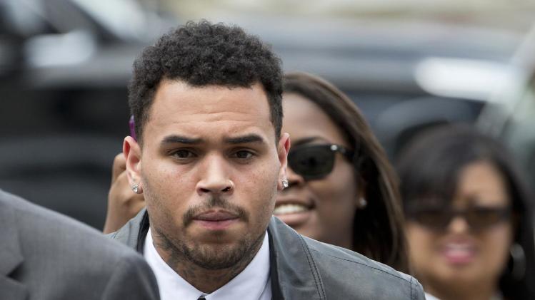 FILE - This June 25, 2014 file photo shows singer Chris Brown arriving at the D.C. Superior Court in Washington. Brown is scheduled to appear in a District of Columbia court for what would be a third attempt at a plea deal to resolve an assault case that dates to October 2013. According to court filings, Brown was scheduled to appear in D.C. Superior Court on Friday for a plea hearing but was unable due to travel issues. The hearing was rescheduled for Tuesday. (AP Photo/Manuel Balce Ceneta, File)