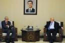 A handout picture released by the official Syrian Arab News Agency (SANA) on October 29, 2013, shows Syrian Deputy Prime Minister Walid al-Moallem (R) meeting with UN-Arab League envoy to Syria Lakhdar Brahimi, in Damascus
