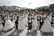 Couples from around the world celebrate after a mass wedding ceremony in Ansan, South Korea, Sunday, Oct. 10, 2010. Some 7,200 South Korean and foreign couples exchanged or reaffirmed marriage vows in the Unification Church's second mass wedding this year.