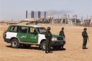Algerian soldiers stand near the Tiguentourine Gas Plant in In Amenas