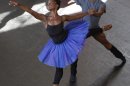 In this Tuesday July 10, 2012 photo, dancer Michaela DePrince, left, rehearses for her lead role in Le Corsaire with dancer Andile Ndlovu in Johannesburg. DePrince, who was born in Sierra Leone escaped civil war and was adopted by a family in the U.S. This will be DePrince's first professional full ballet role. (AP Photo Denis Farrell)