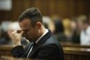 Oscar Pistorius reacts as he listens to forensic evidence being given in court in Pretoria, South Africa, Wednesday, April 16, 2014. Pistorius is charged with the murder of his girlfriend, Reeva Steenkamp, on Valentines Day in 2013. (AP Photo/Gianluigi Guercia, Pool)