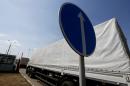 Trucks of a Russian convoy carrying humanitarian aid for Ukraine drive onto the territory of Russia-Ukraine border crossing point "Donetsk" in Russia's Rostov Region