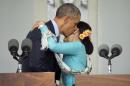 U.S. President Barack Obama, left, embraces and kisses Myanmar's opposition leader Aung San Suu Kyi during a news conference at her home in Yangon, Myanmar Friday, Nov. 14, 2014. (AP Photo/Pablo Martinez Monsivais)