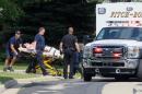 FILE - In this Aug. 22, 2014 file photo emergency personnel transport Andy Steele from his home in Fitchburg, Wis., where authorities said Steele's wife, Ashlee Steele and sister-in-law, Kacee Tollesfsbol, were found shot dead. Authorities said Tuesday, Aug. 26, 2014 that Tollefsbol called 911 around 1 p.m. Friday and said Andy Steele had shot her in the back. Andy Steele was arrested but hasn't been charged. (AP Photo/Wisconsin State Journal, John Hart, File)