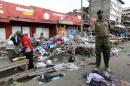 A policeman secures the scene of twin explosions at the Gikomba open-air market for second-hand clothes in Nairobi
