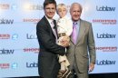 Executive chairman of Loblaw Companies Limited Galen G Weston holds his son Graydon, as they pose with W. Galen Weston (R) in Toronto