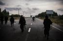 Pro-Russian militants patrol along a road near Donetsk, eastern Ukraine on August 18, 2014