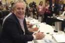 Quebec Premier Jean Charest smiles during a photo op before a meeting.