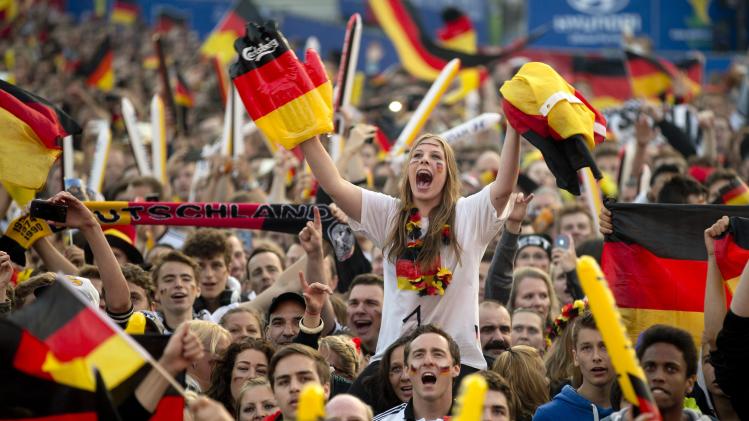 German soccer fans cheer during 2014 World Cup Group G soccer match between Germany and Ghana at a public viewing zone called &#39;fan mile&#39; in Berlin
