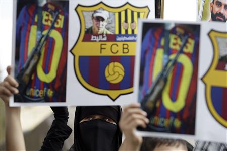 Palestinians protest against the presence of former Israeli captive soldier Shalit at the upcoming Spanish first division soccer match between Barcelona and Real Madrid, during a demonstration in Jerusalem