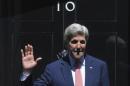 U.S. Secretary of State Kerry gestures on the steps of the British Prime Minister's official residence at Downing Street as he leaves, in London, Britain