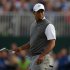 Tiger Woods of the U.S. walks across the 18th green during the third round of the British Open golf championship at Royal Lytham & St Annes