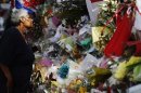 A woman looks at floral tributes, left for British soldier Lee Rigby, outside an army barracks near the scene of his killing in Woolwich, southeast London