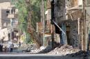 Syrians walk in a heavily damaged street in the eastern town of Deir Ezzor on August 26, 2013