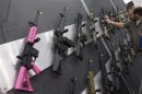 A pink assault rifle hangs among others at an exhibit booth at the George R. Brown convention center, the site for the National Rifle Association's (NRA) annual meeting in Houston, Texas