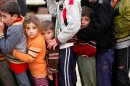 Children line up to receive aid on the Syrian-Turkish border.