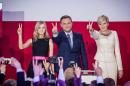 Andrzej Duda (C), presidential candidate of PiS celebrates with his wife Agata (R) and daughter Kinga after the announcement of the exit poll results of the second round of the presidential election in Warsaw, on May 24, 2015