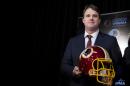 New Washington Redskins head coach Jay Gruden holds a Redskins helmet at the Redskins Park in Ashburn, Va., Thursday, Jan. 9, 2014. Jay Gruden was introduced as the new Washington Redskins head coach, replacing Mike Shanahan and becoming the team's eighth head coach since Daniel Snyder purchased the franchise in 1999. (AP Photo/Manuel Balce Ceneta)
