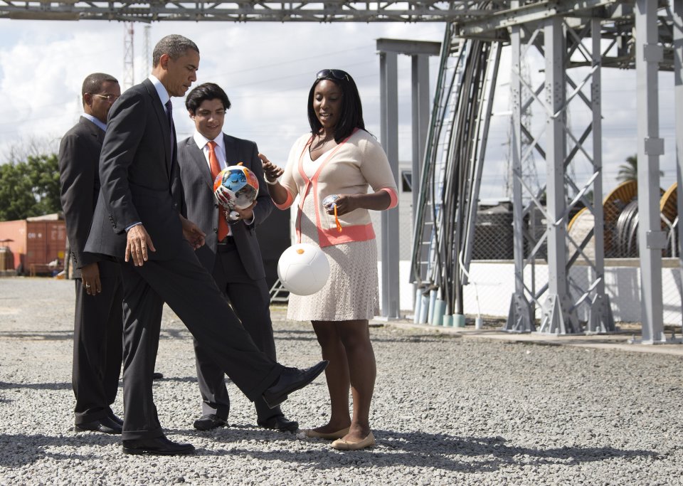 U.S. President Barack Obama demonstrates "the Soccket Ball," which uses kinetic energy to provide power to charge a cell phone or power a light, during an event at the Ubungo power plant to promote energy innovation on Tuesday, July 2, 2013, in Dar Es Salaam, Tanzania. The president is traveling in Tanzania on the final leg of his three-country tour in Africa. (AP Photo/Evan Vucci)